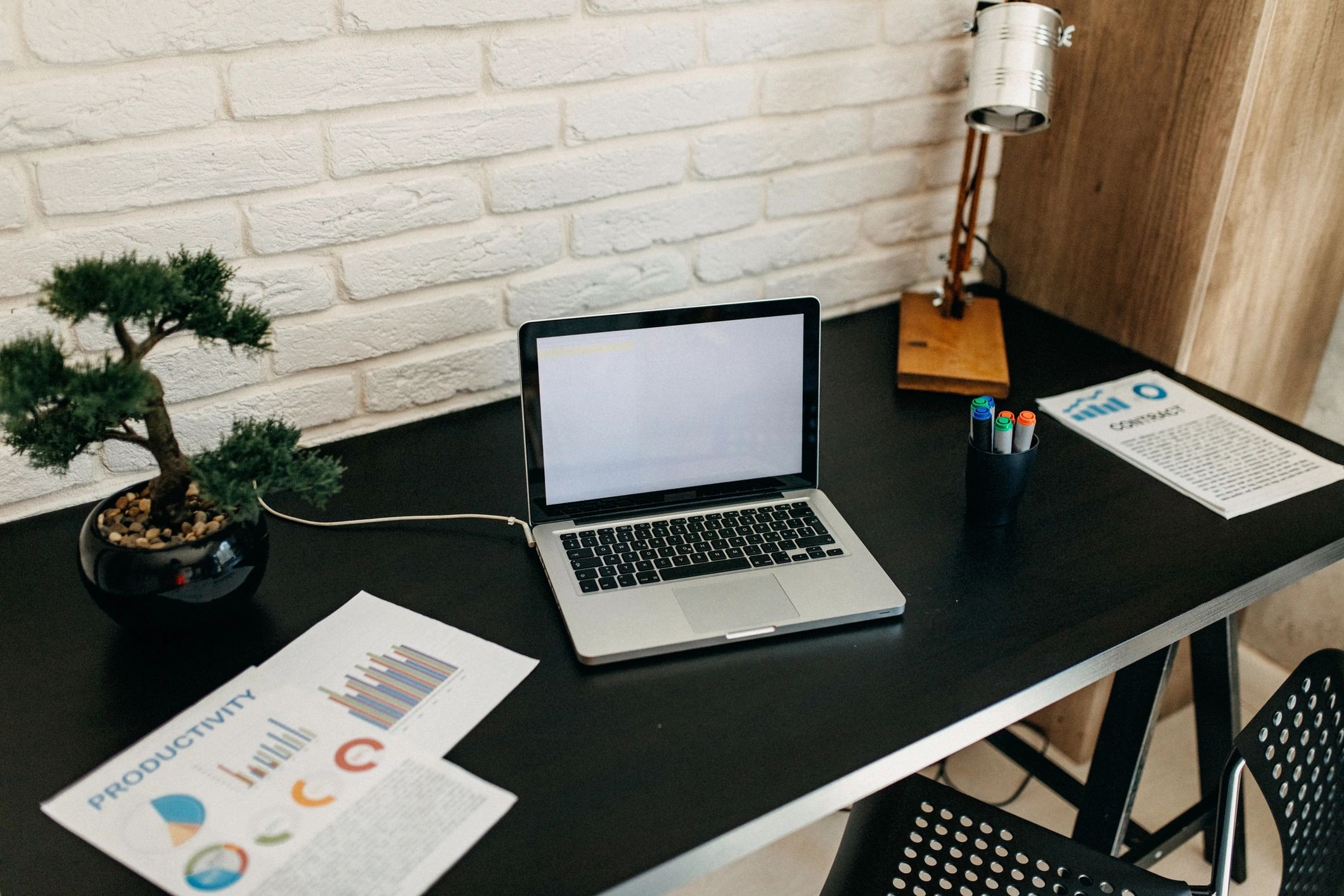 Marketing workspace with laptop and planning materials